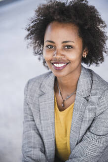 Portrait of smiling young businesswoman outdoors - UUF20206