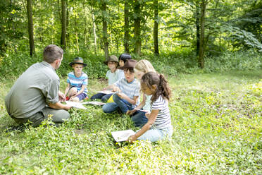 School children learning to distinguish animal species in forest - WESTF24495