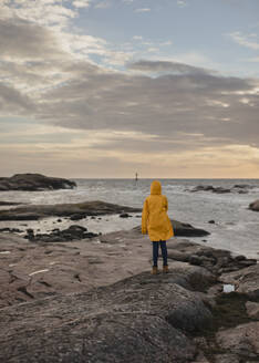 Woman on rocky coast - JOHF05265