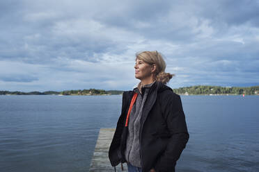 Woman at lake looking away - JOHF05353