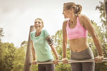 Women during workout on high bar in park - SDAHF00041