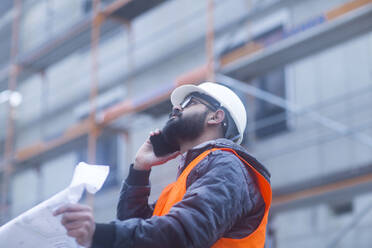 Construction engineer on the phone at construction site - SGF02580