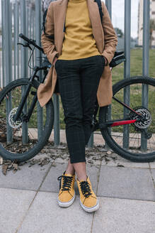 Tiefschnitt eines stilvollen jungen Mannes mit Fahrrad in der Stadt - GRCF00102