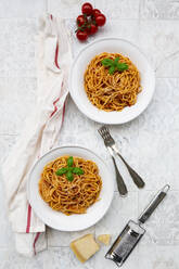 Plates of spaghetti with tomato sauce, Parmesan cheese and basil - LVF08528