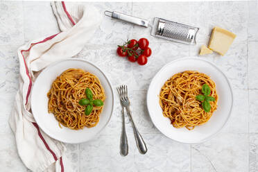 Plates of spaghetti with tomato sauce, Parmesan cheese and basil - LVF08529
