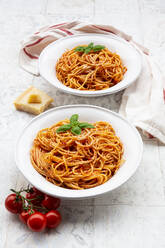 Plates of spaghetti with tomato sauce, Parmesan cheese and basil - LVF08530