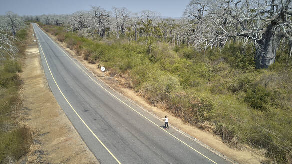 Luftaufnahme einer Frau, die per Anhalter unterwegs ist, Region Cabo Ledo, Angola - VEGF01446