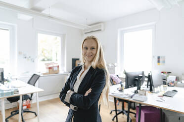 Portrait of a smiling young businesswoman in office - GUSF03195