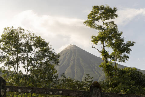 Costa Rica, Alajuela Province, La Fortuna, Trees against Arenal Volcano stock photo