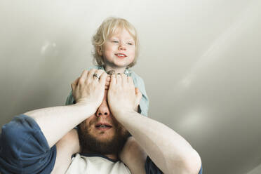 Vater trägt seine kleine Tochter auf den Schultern nach Hause - IHF00258