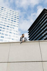 Casual young businessman on the phone in the city - JRFF03984