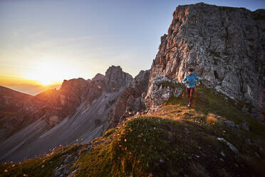 Mature man trai running on mountain ridge at Axame Lizum, Austria - CVF01522