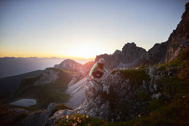 Woman climbing mountain ridge at Axamer Lizum, Austria - CVF01524