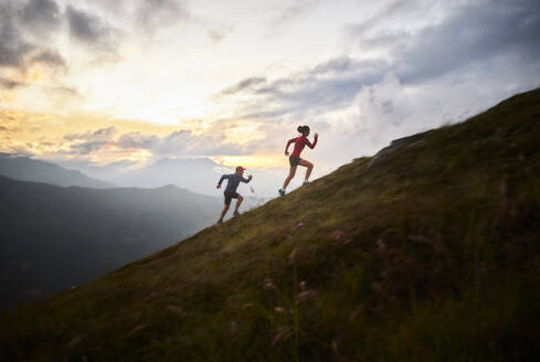 Mann und Frau laufen bergauf in den Bergen - CVF01525