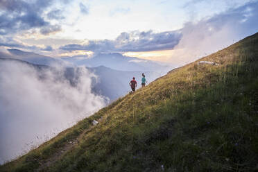 Man and woman running uphill in the mountains - CVF01530