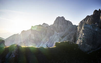 Woman running on mounitain ridge at Axamer Lizum, Austria - CVF01539