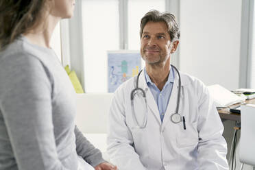 Doctor with female patient in his medical practice - PHDF00053