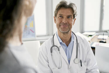 Doctor with female patient in his medical practice - PHDF00054