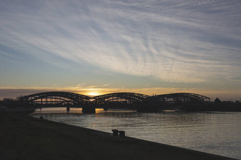 Germany, Hamburg, Silhouette of Elbbrucken bridge at sunrise - ASCF01066