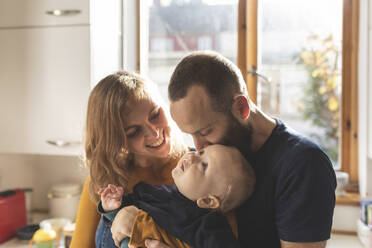 Happy affectionate family in the kitchen at home - WPEF02472