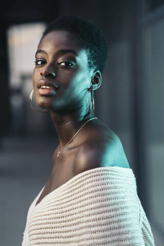 Portrait of self-confident young woman wearing earrings stock photo