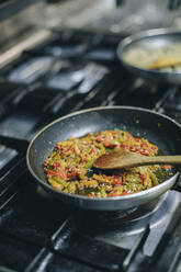 Close-up of a dish in pan in restaurant kitchen - OCAF00452