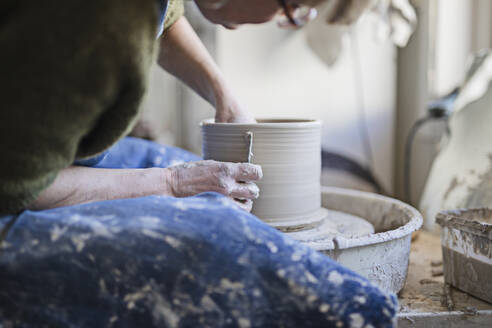 Potter using potters wheel - JOHF05850