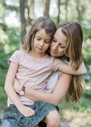 Mother and daughter sitting together - JOHF05949