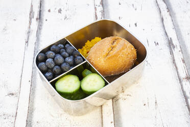 Lunch box with cucumber slices, blueberries and bun with lentil paste - LVF08548