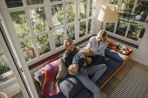 Happy family in sunroom at home - KNSF07003