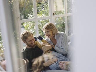 Happy family in sunroom at home - KNSF07032