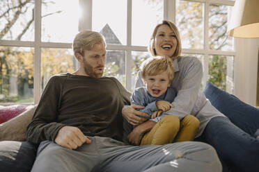 Happy family in sunroom at home - KNSF07075