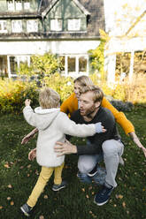 Happy affectionate family in garden - KNSF07098