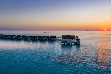 Maldives, South Male Atoll, Aerial view of lagoon of the Maldives island of Maadhoo at sunset - AMF07774