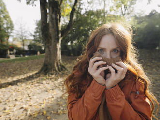 Portrait of a redheaded woman in a park in autumn - KNSF07156