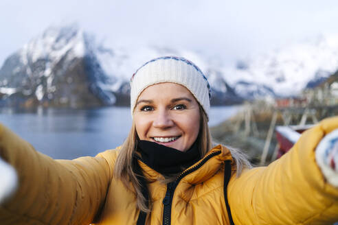 Selfie of smiling tourist at Hamnoy, Lofoten, Norway - DGOF00089