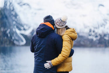 Tourist couple enjoying the view at Hamnoy, Lofoten, Norway - DGOF00144