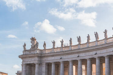 Italy, Rome, Sculptures standing on top of colonnade of Saint Peters Square - MMAF01208