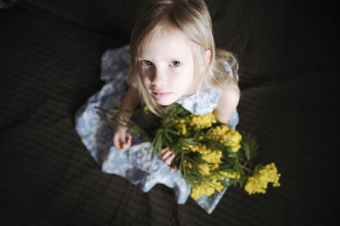 Portrait of blond little girl with bunch of mimosa - EYAF00909
