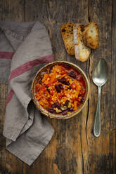 Bowl of vegan chili with red lentils, celery sticks, kidney beans, tomatoes and carrots - LVF08572