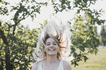 Portrait of blond young woman with blowing hair in summer - BFRF02181