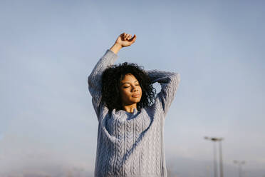 Beautiful young woman outdoors under blue sky - TCEF00103