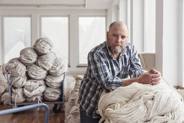Portrait of a confident mature man in a textile factory - SDAHF00074