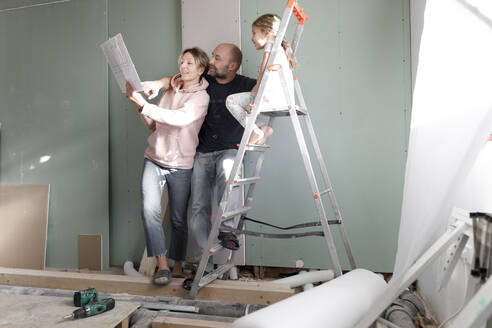 Familie auf der Baustelle zu Hause beim Planstudium - KMKF01218