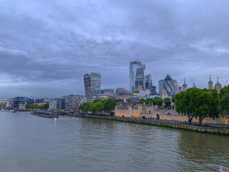 England, London, The City, Skyscrapers seen across river at dusk - LOMF00986