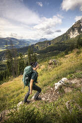 Woman with dog hiking at Wilder Kaiser, Kaiser mountains, Tyrol, Austria - MSUF00161