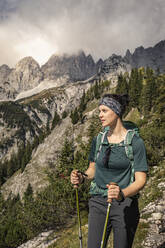 Woman on a hiking trip at Wilder Kaiser enjoying the view, Kaiser mountains, Tyrol, Austria - MSUF00163