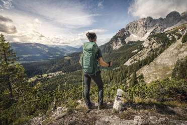 Woman on a hiking trip at Wilder Kaiser enjoying the view, Kaiser mountains, Tyrol, Austria - MSUF00164