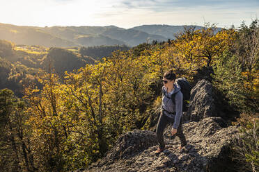 Woman hiking on rocky trail, Karlsruher Grat, Ottenhoefen, Black Forest, Germany - MSUF00180