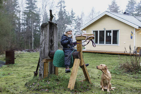 Girl with dog in garden - JOHF06242